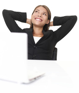 Cheerful business woman looking up